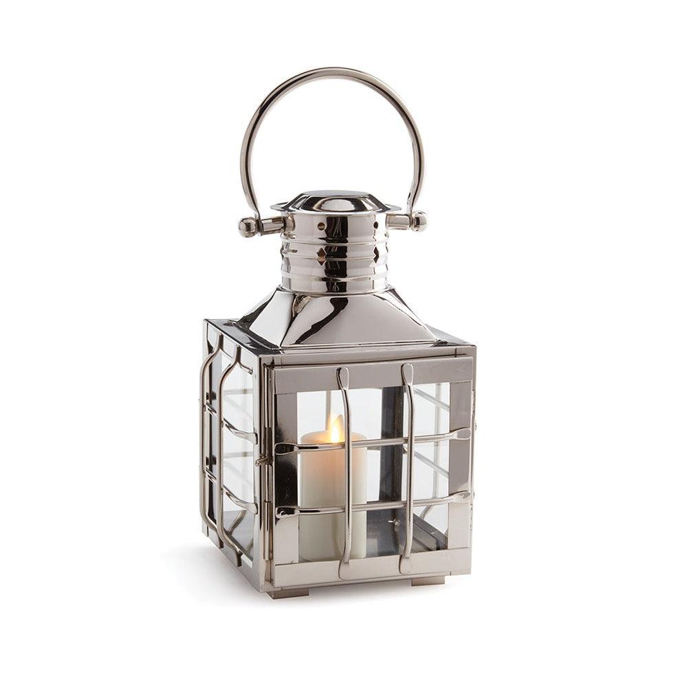 a metal lantern with a candle inside of it