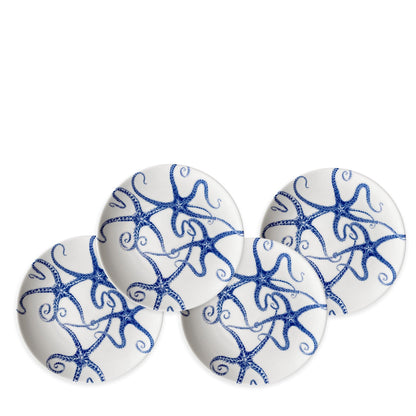 	Four matching white porcelain appetizer plates with detailed blue starfish and curling arms