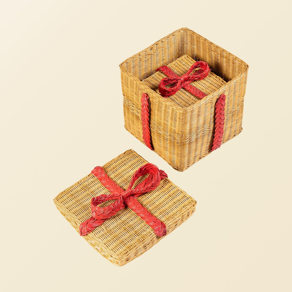 	Small rattan gift box nested inside the larger open box, with the large red-bow lid beside it