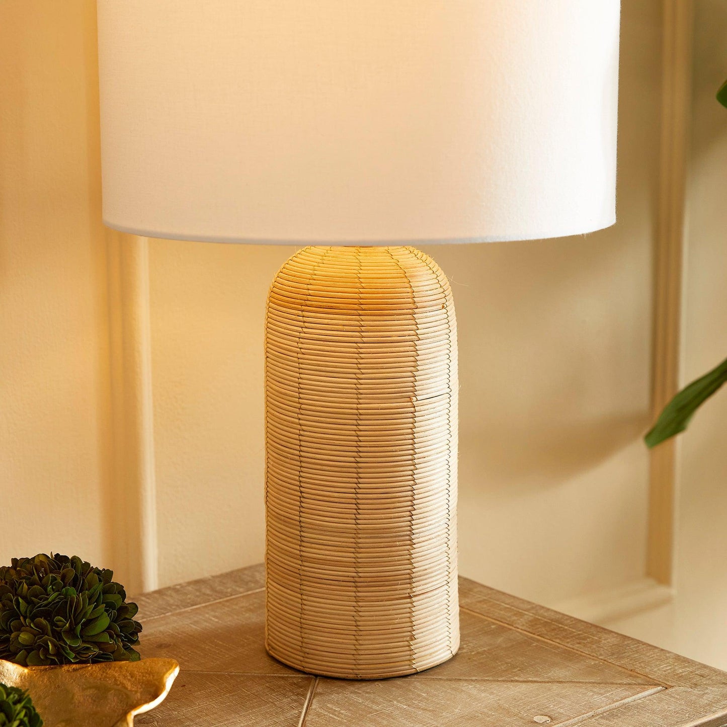 a table with a lamp and a plant on it