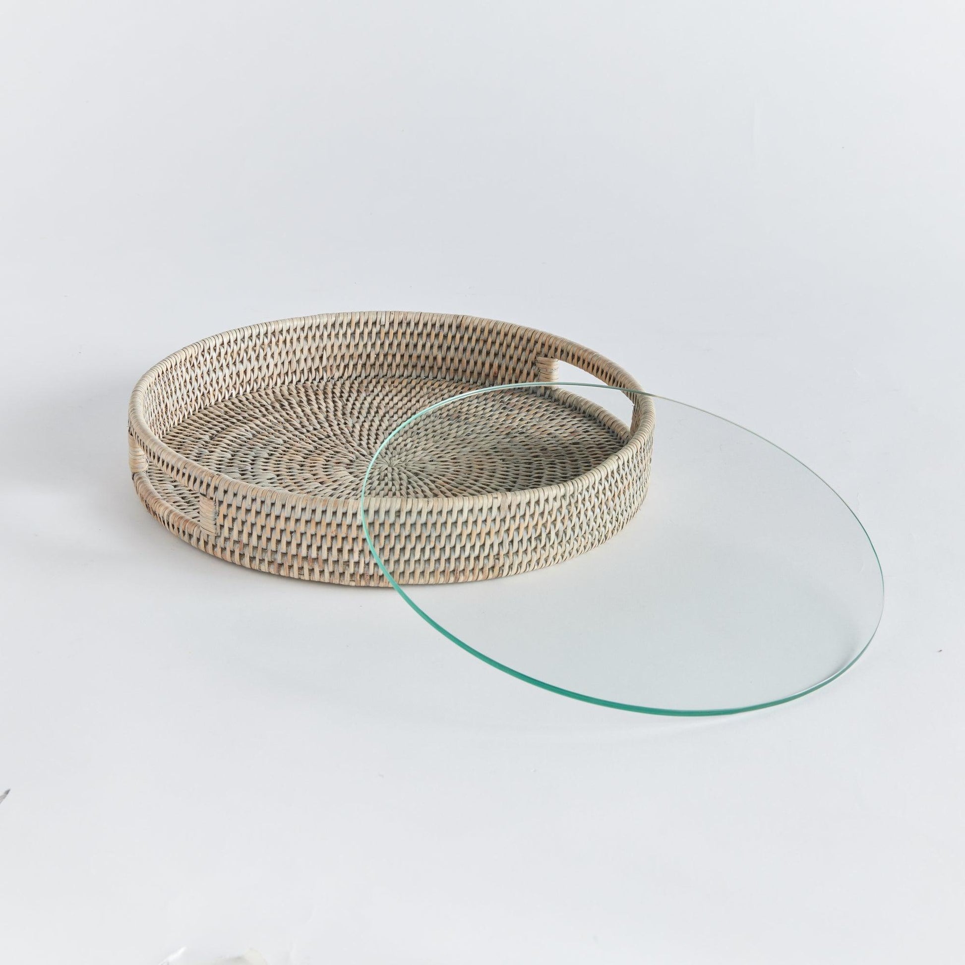 a glass and wicker tray on a white background