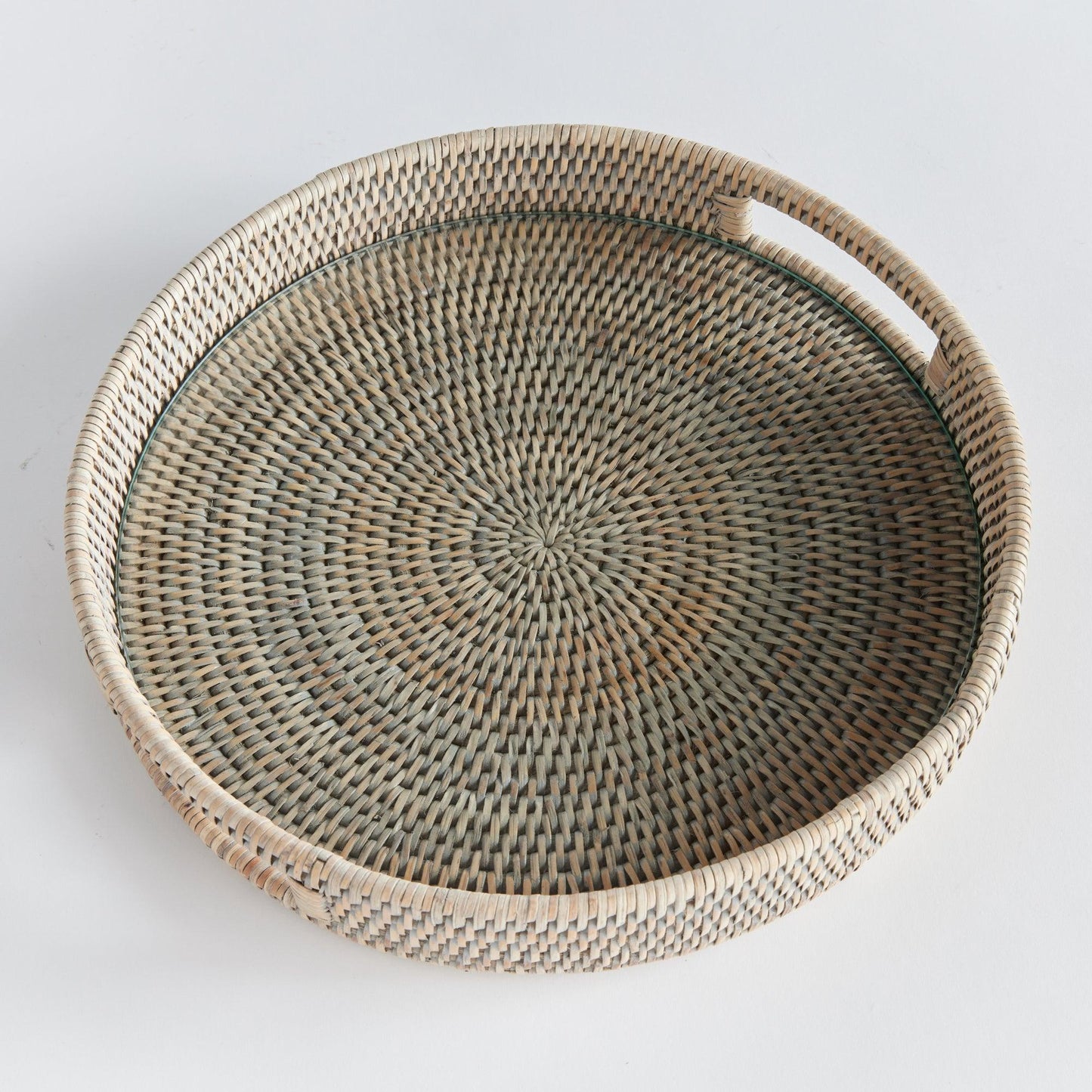 a wicker tray with a handle on a white background