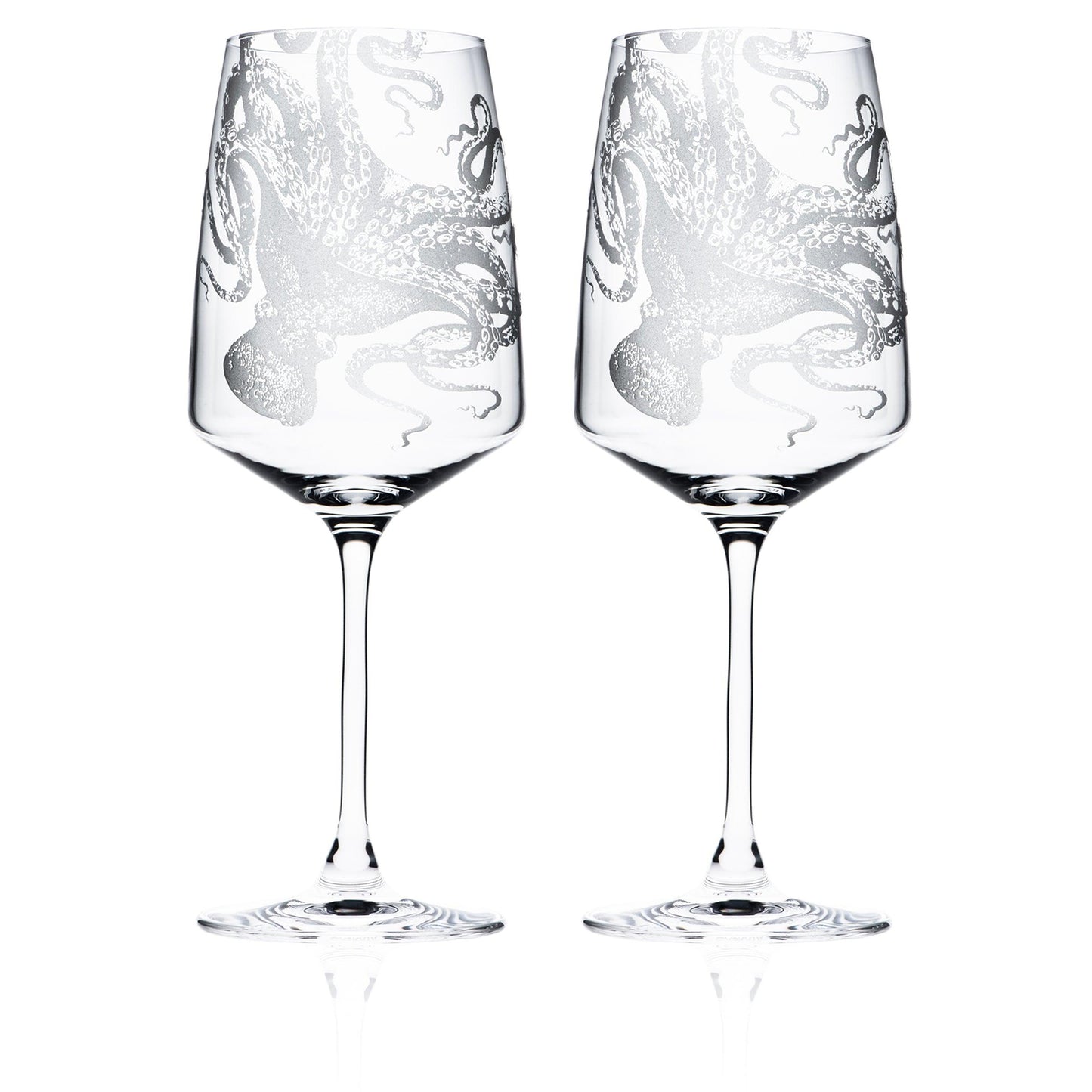 a pair of wine glasses sitting next to each other