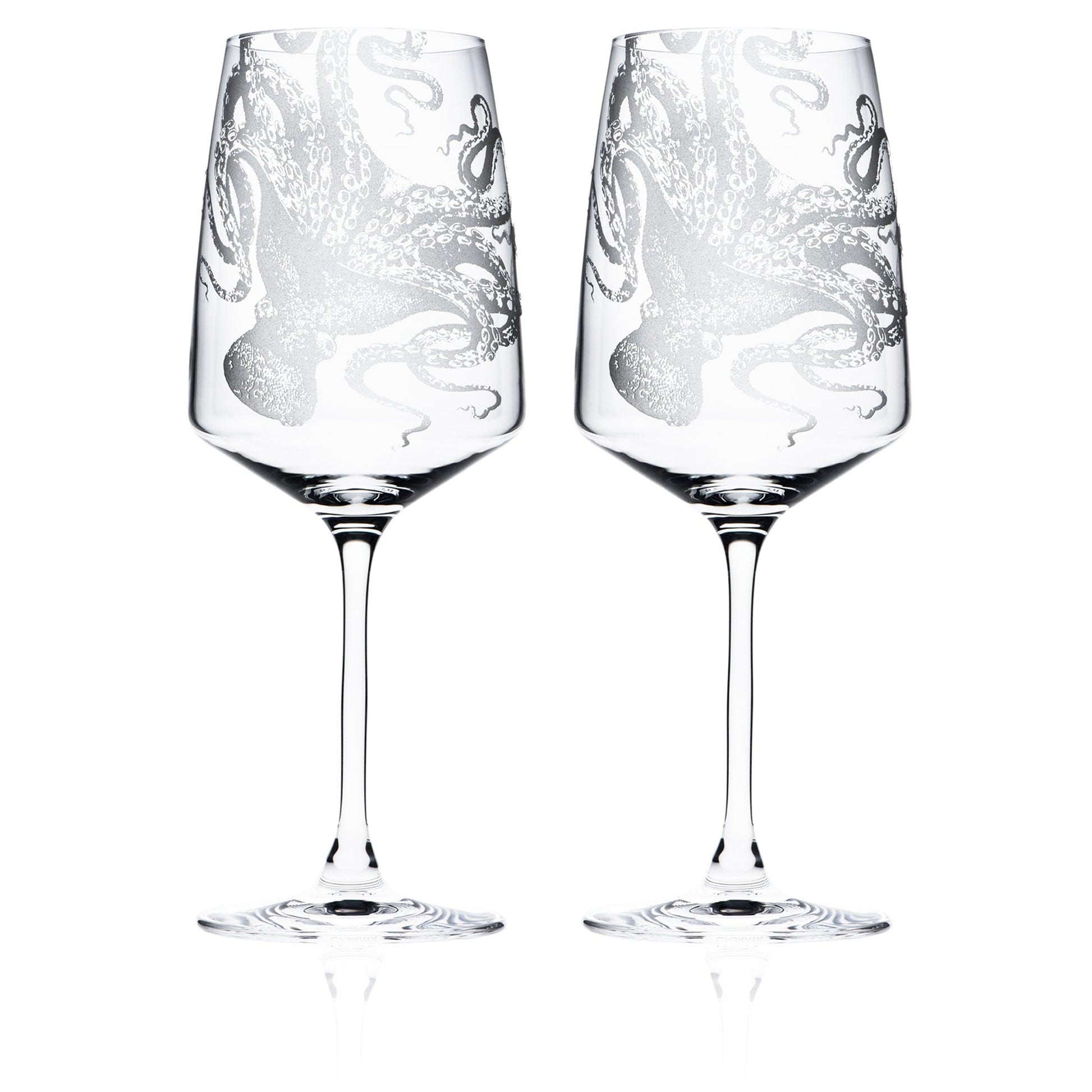 a pair of wine glasses sitting next to each other