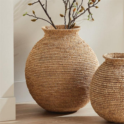 two large vases sitting next to each other on a table