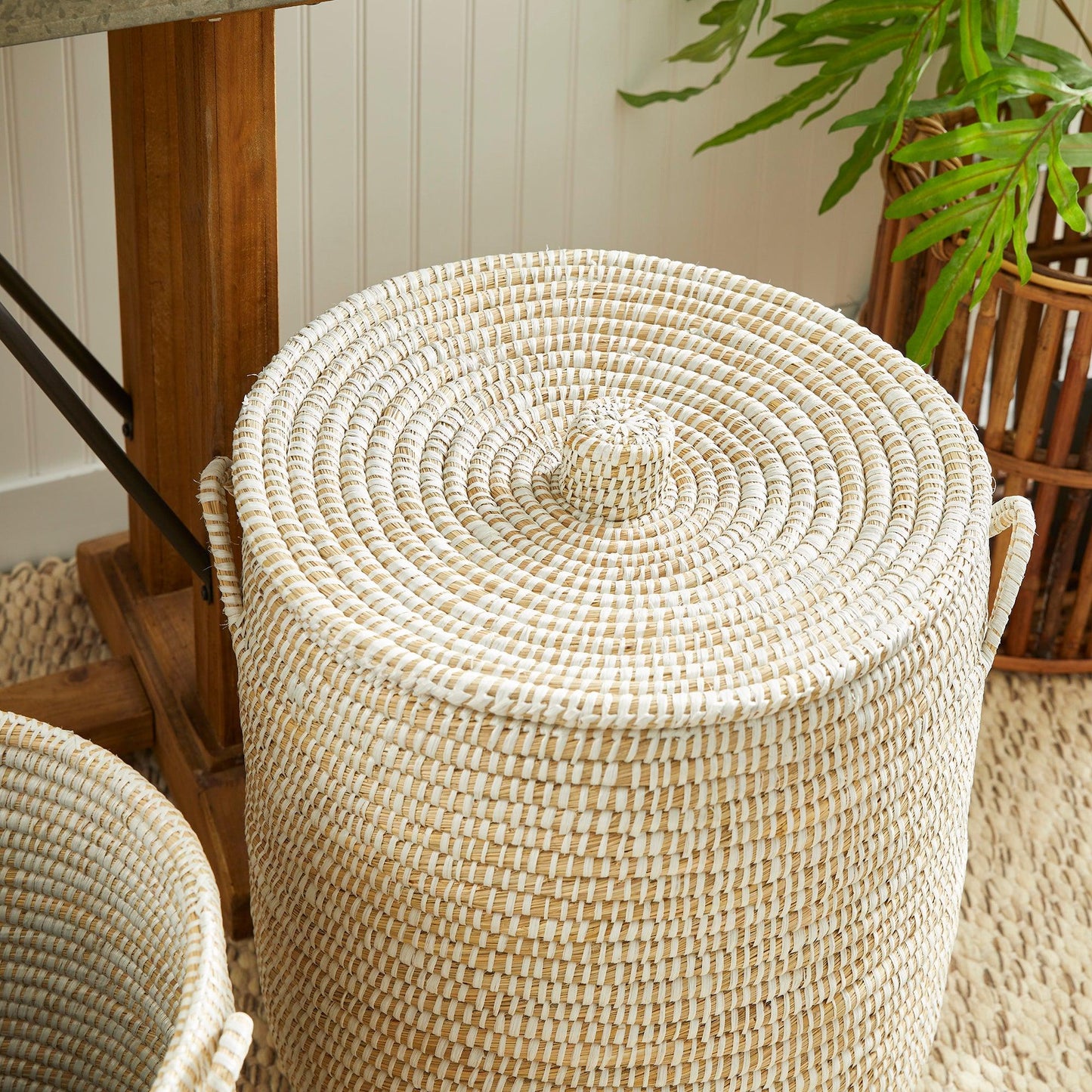 a large round wicker ottoman sitting on top of a rug