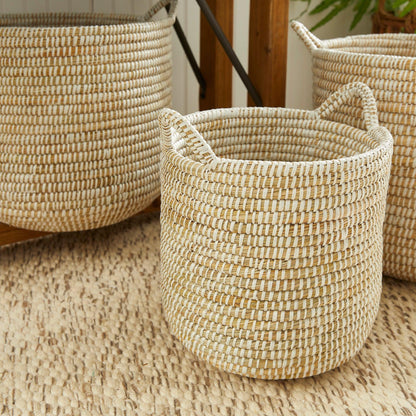 three woven baskets sitting on top of a rug