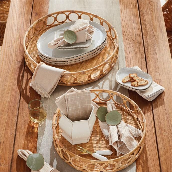 a wooden table topped with plates and bowls