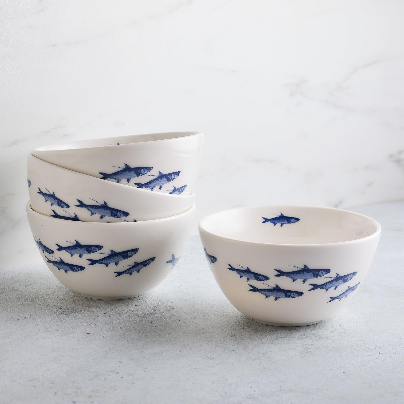 a set of four blue and white bowls