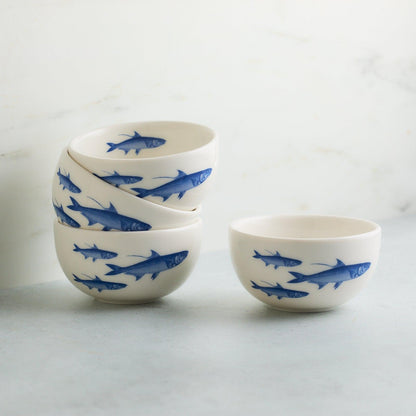 Four matching School of Fish snack bowls, with three stacked beside one individual bowl