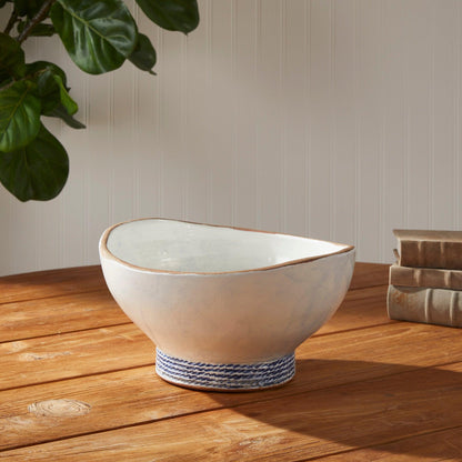 a white bowl sitting on top of a wooden table
