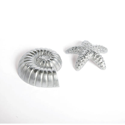 Two silver game pieces 