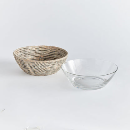 rattan serving bowl next to clear plastic serving bowl