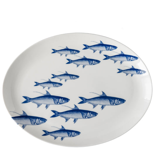 a blue and white plate with fish on it