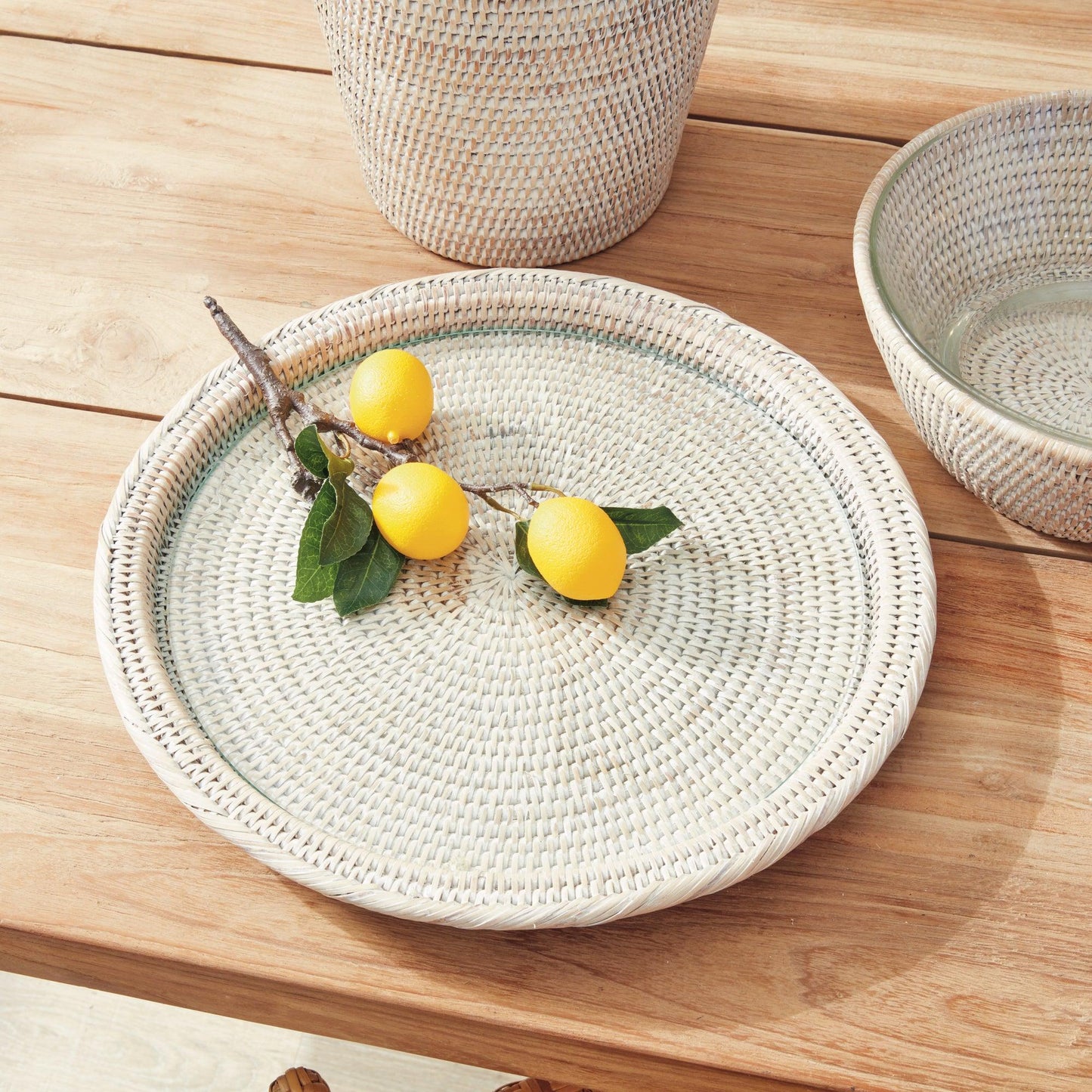 round rattan tray on a table with lemons