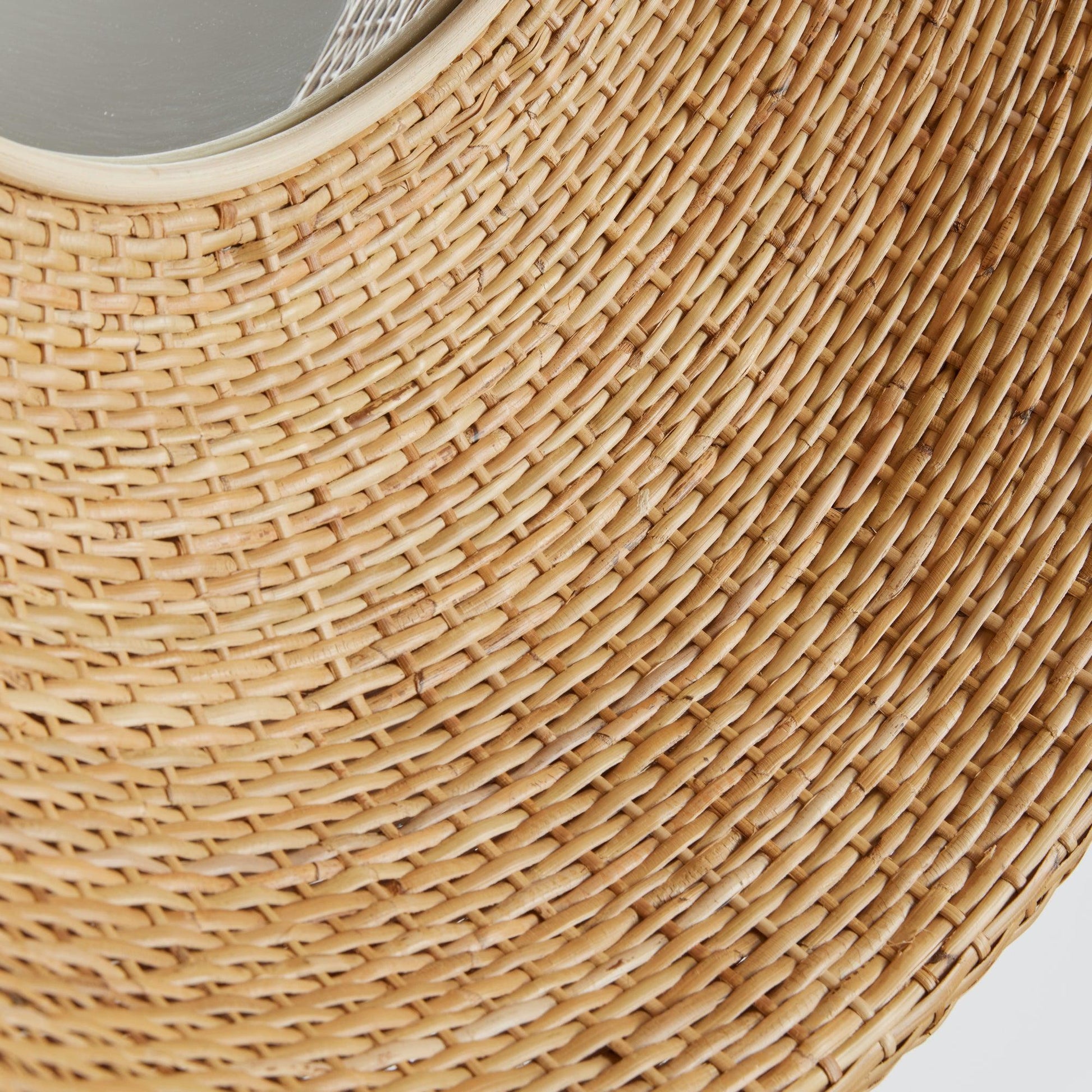 a close up of a woven basket with a mirror