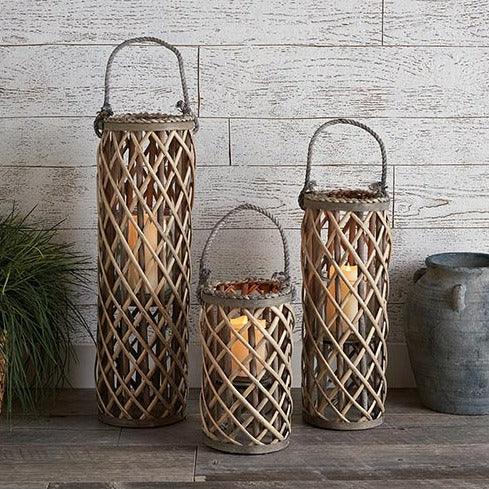 a group of three lanterns sitting on top of a table