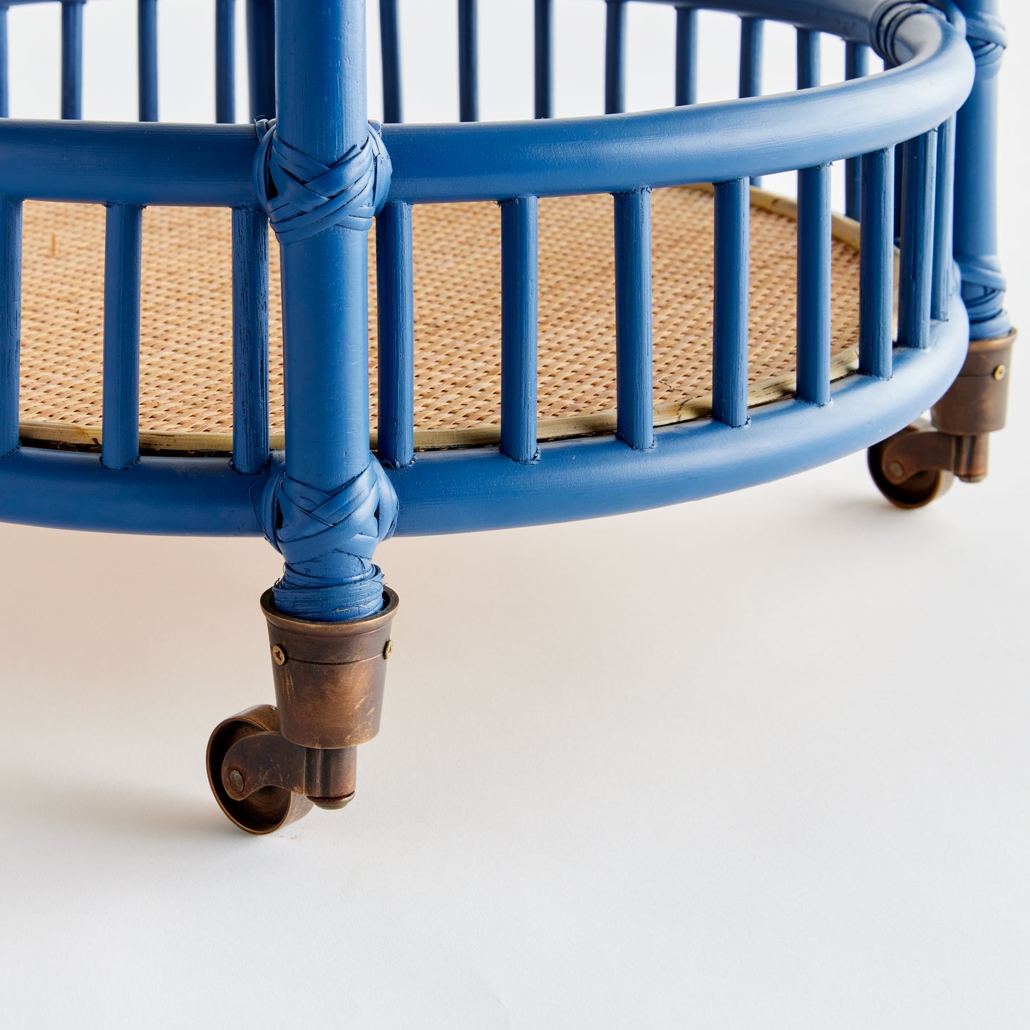 close up of blue rattan bar cart wheels