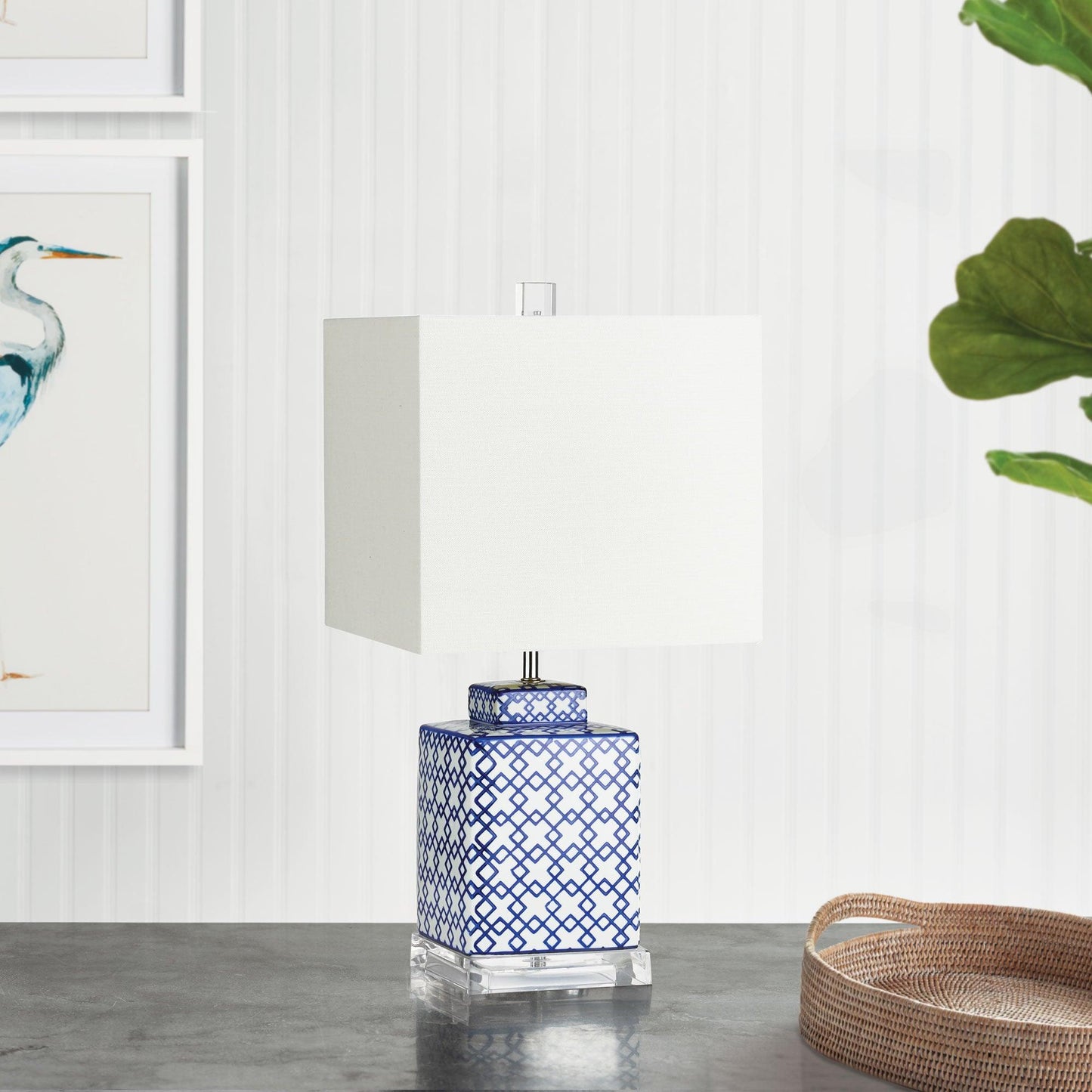 a blue and white table lamp sitting on top of a table