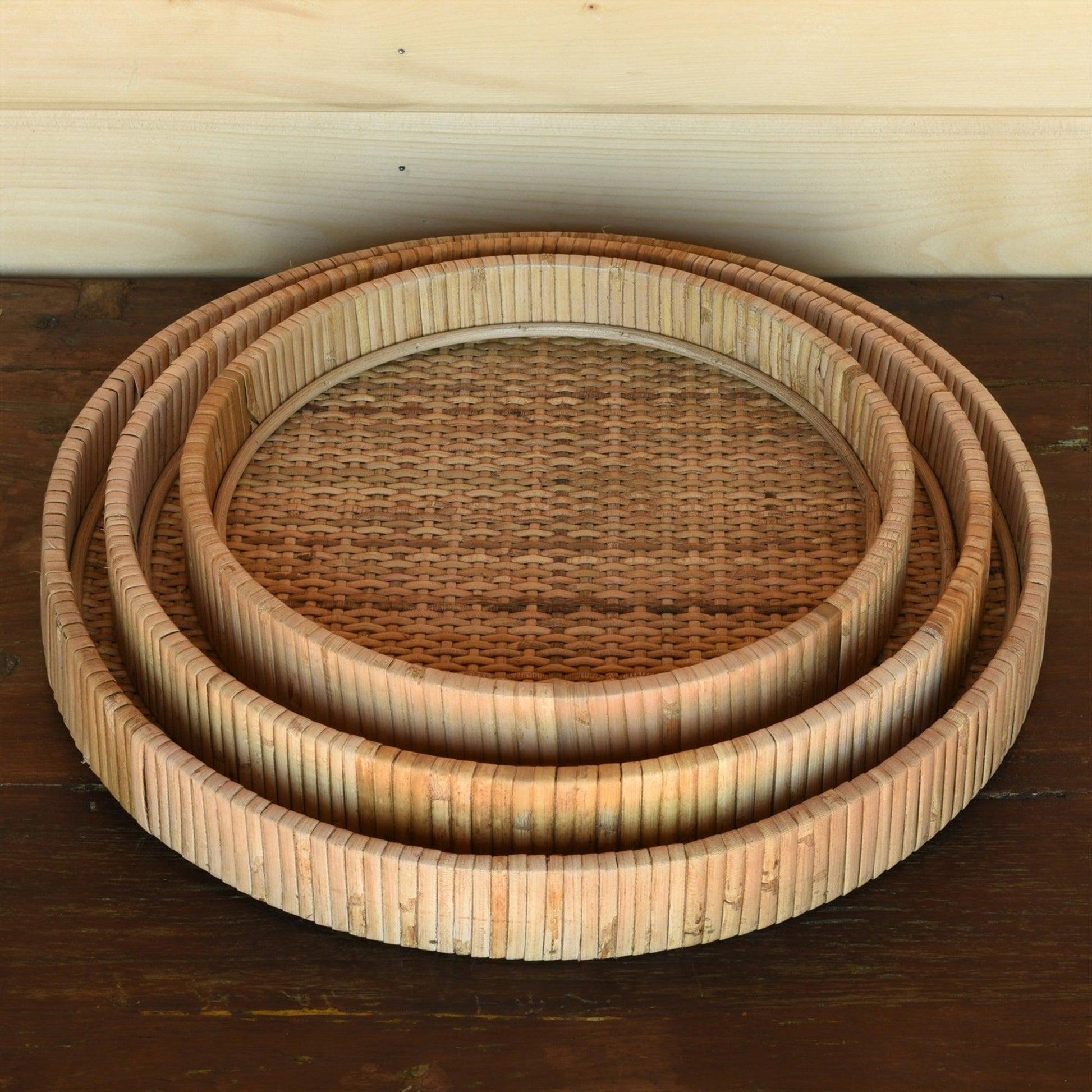 three stacked round rattan trays