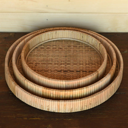 three stacked round rattan trays