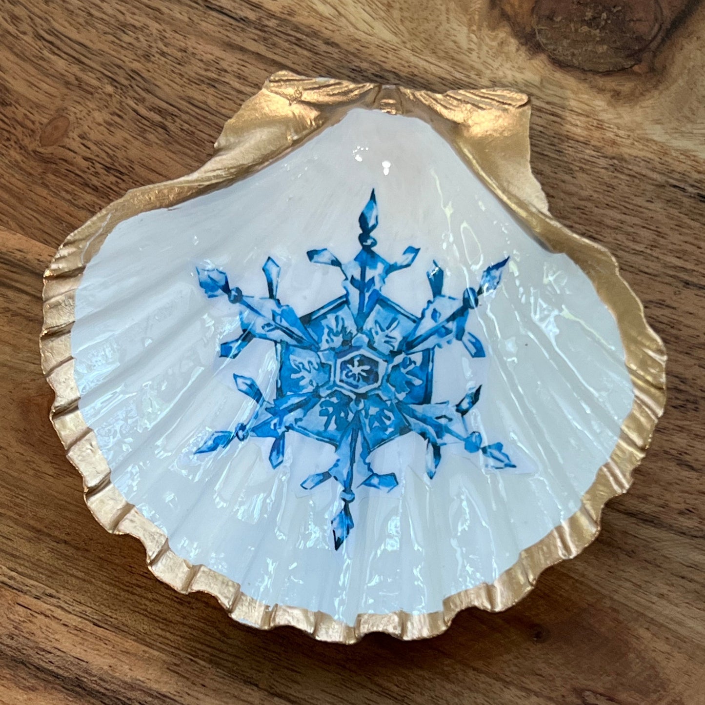 gold and white shell with blue snowflake