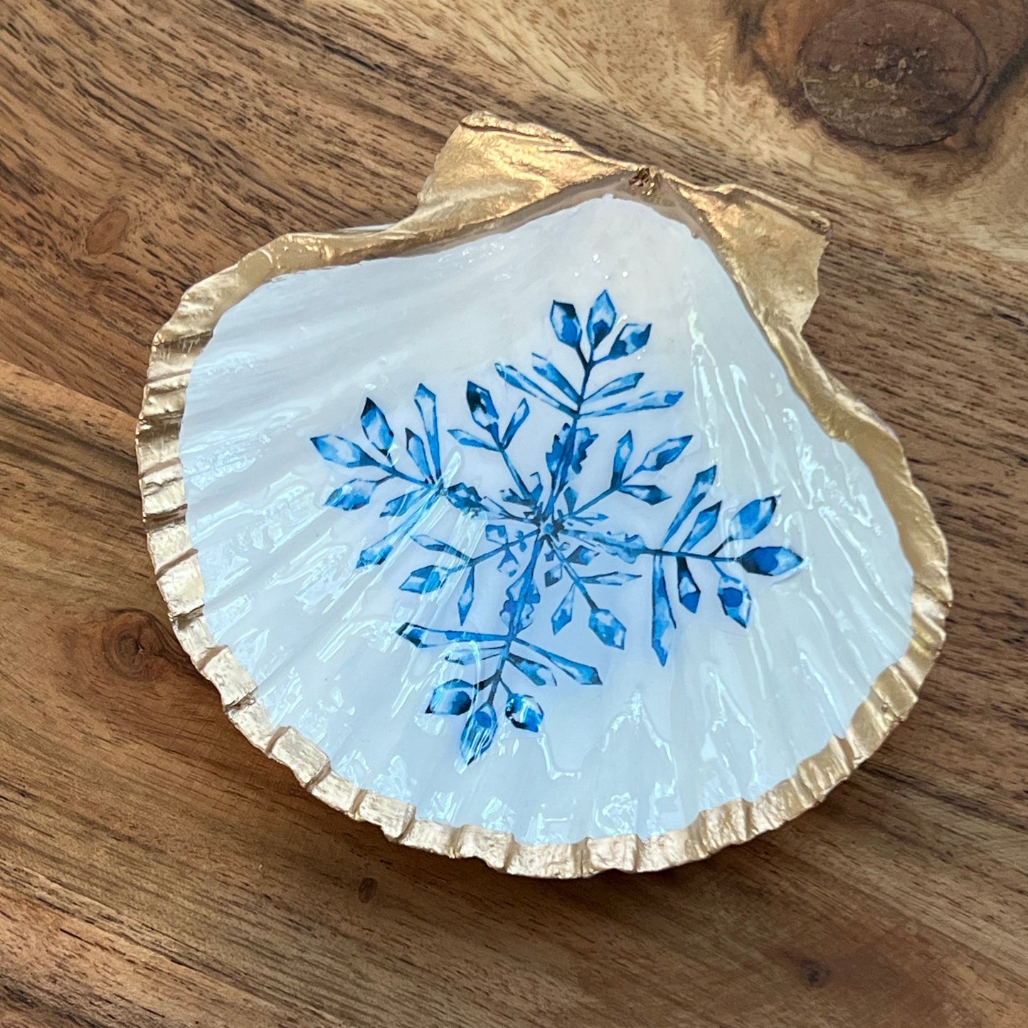 gold and white shell with blue snowflake