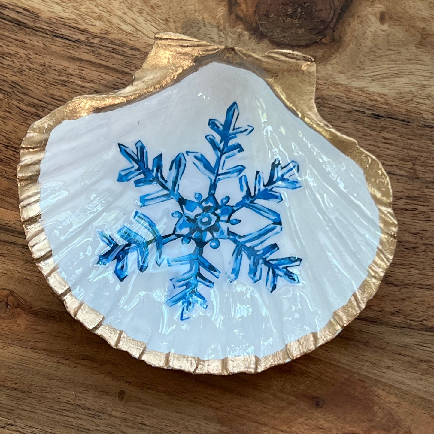 gold and white shell with blue snowflake