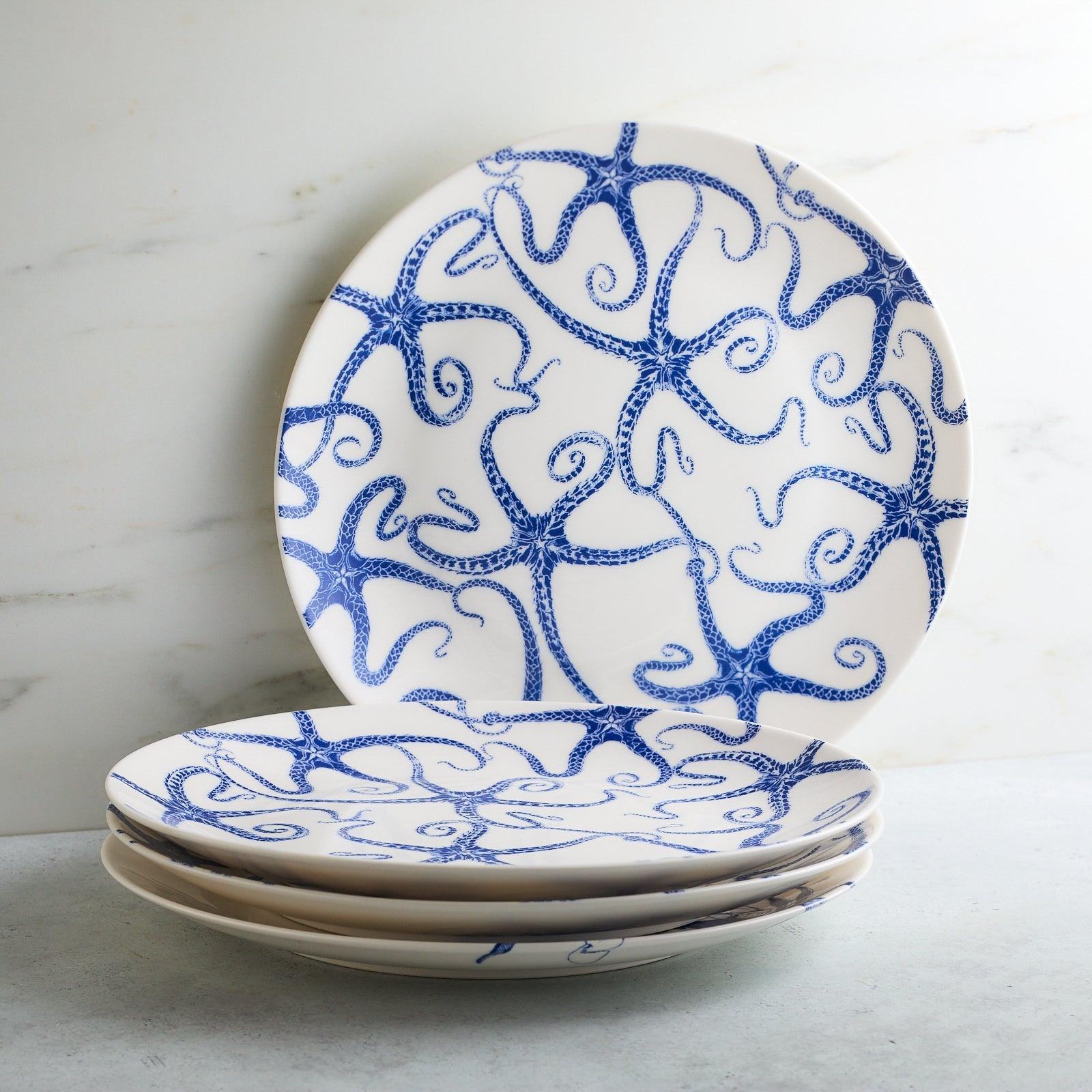 a set of three blue and white plates