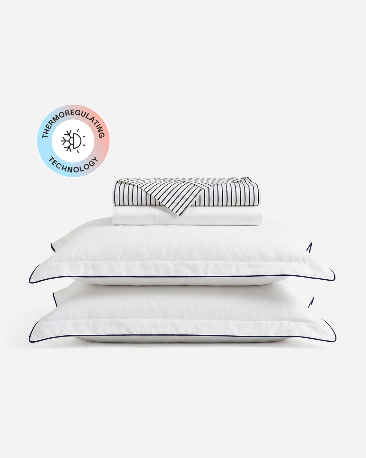 Porto cooling sheet set with folded sheets, two blue-trimmed white pillowcases, and a temperature-regulating badge