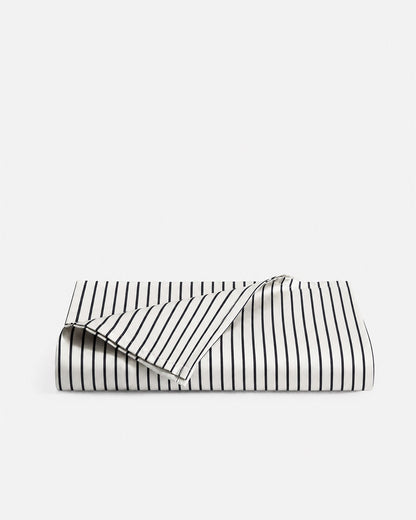Folded Porto bamboo viscose cooling top sheet in white with midnight blue stripes
