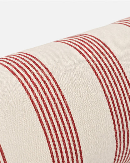 Close-up of the Rimini bolster pillow showing cotton fabric and fine terracotta stripe detailing