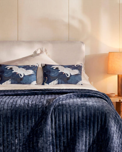 Crane in the Clouds velvet pillow styled on bed