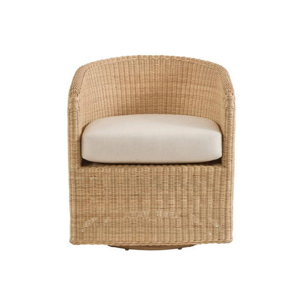 a wicker chair with a white cushion