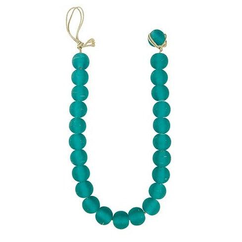 a long decoration with turquoise beads on a white background