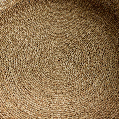 a close up view of a round woven placemat