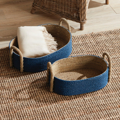a pair of baskets sitting on top of a rug