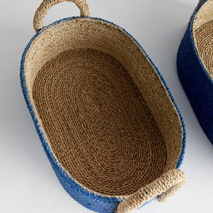 a pair of blue and brown baskets sitting on top of a white table