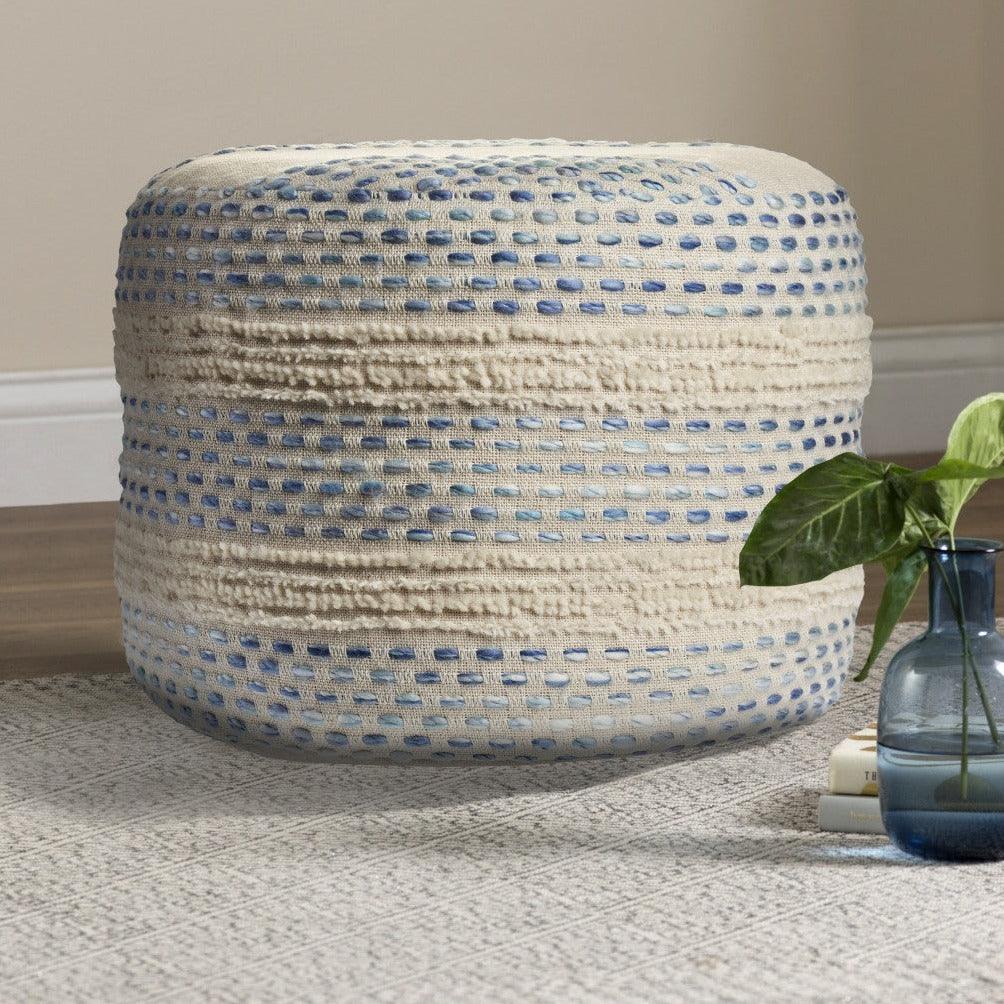 a blue and white basket sitting on top of a wooden floor