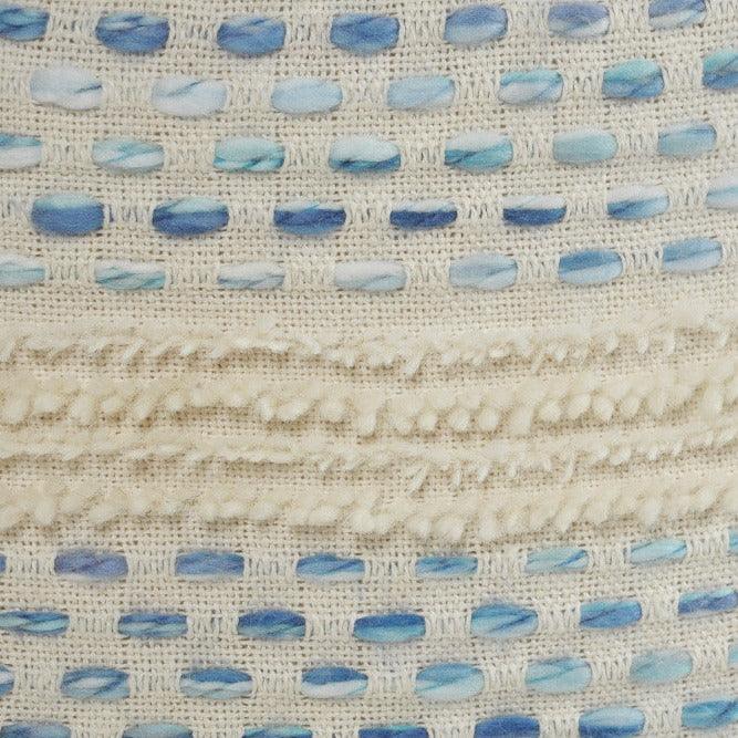 a close up of a blue and white pouf