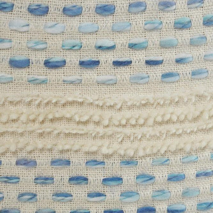 a close up of a blue and white pouf