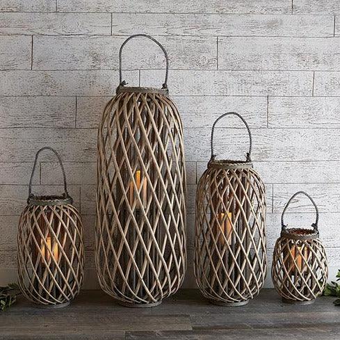 a group of three wicker lanterns sitting on top of a wooden table