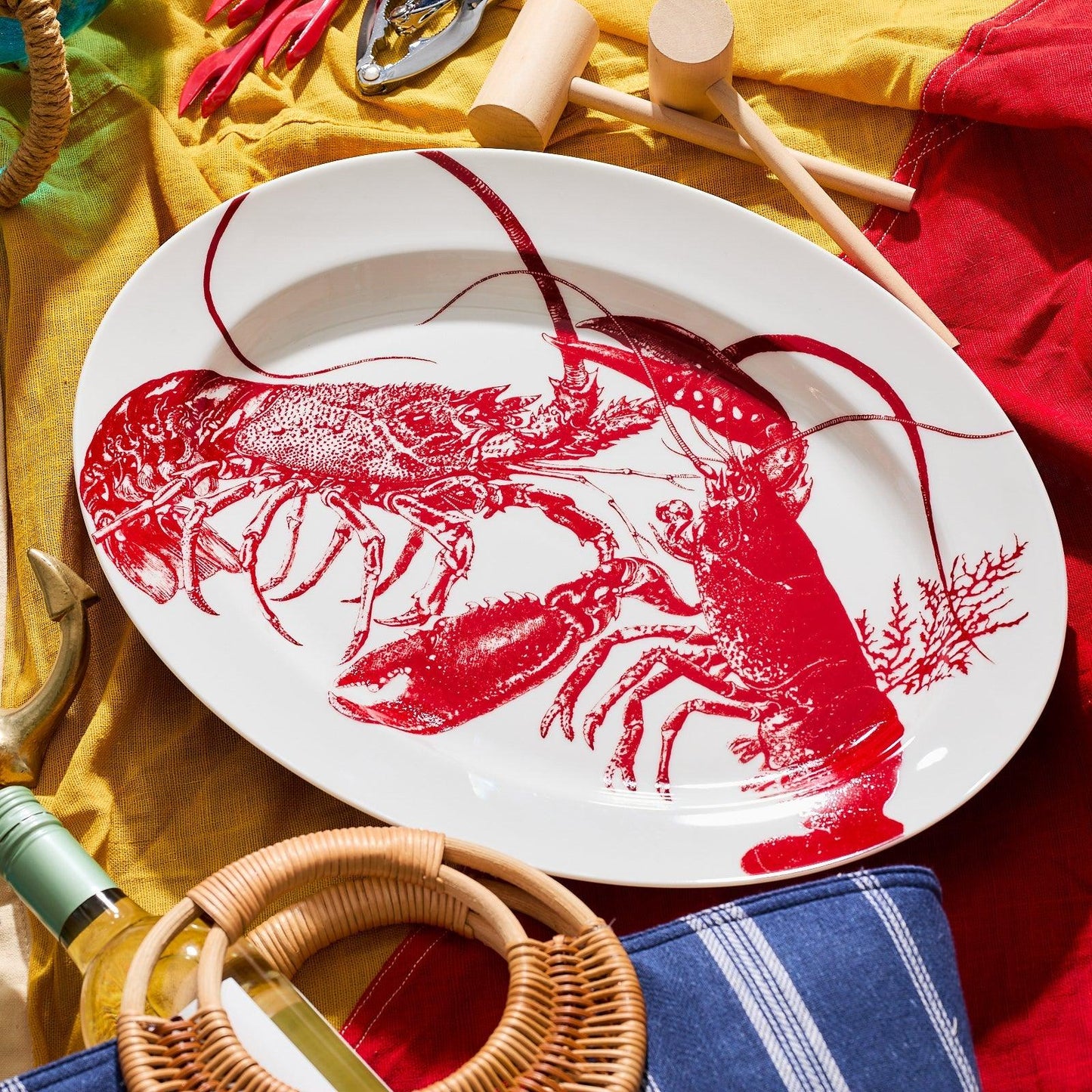 a white plate with a red lobster on it