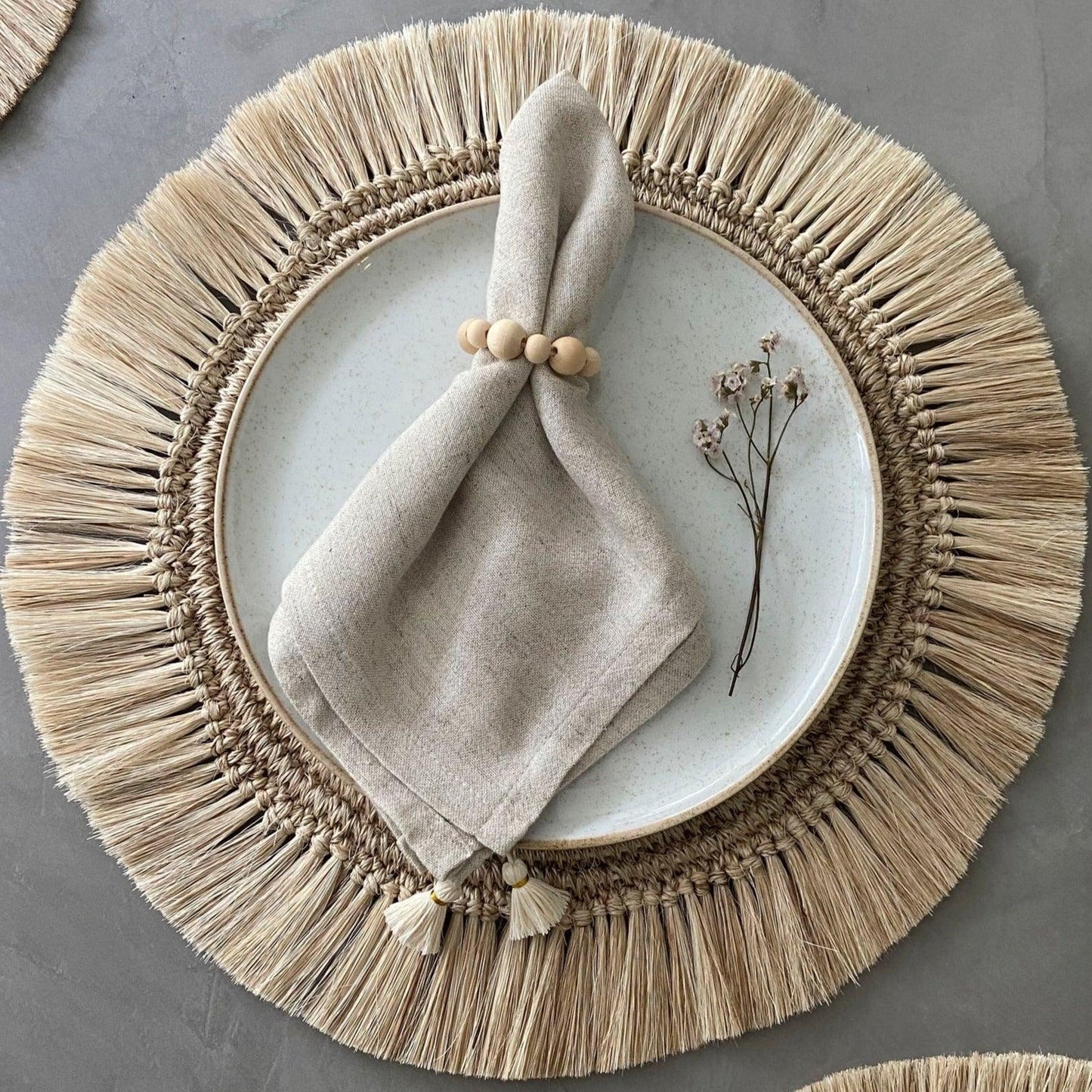 place setting with tan placemat and napkin